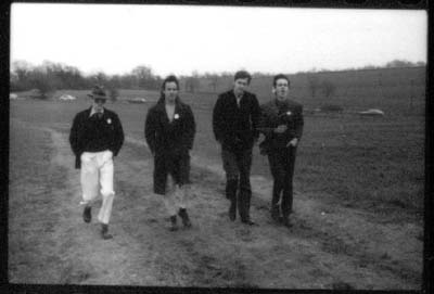 grainy black and white print of posing in winter countryside