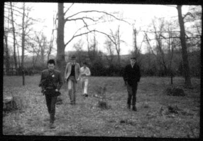 grainy black and white print of posing in winter countryside