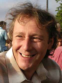 colour photograph of a man smiling into low sunlight