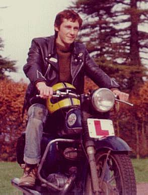 colour photograph of a young man sitting proudly on an old BSA Bantam motorbike