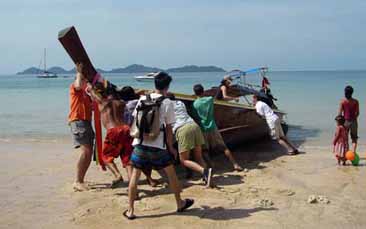 colour photograph of a Thai longboat on a beach